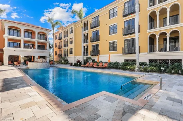 a view of a swimming pool with outdoor seating