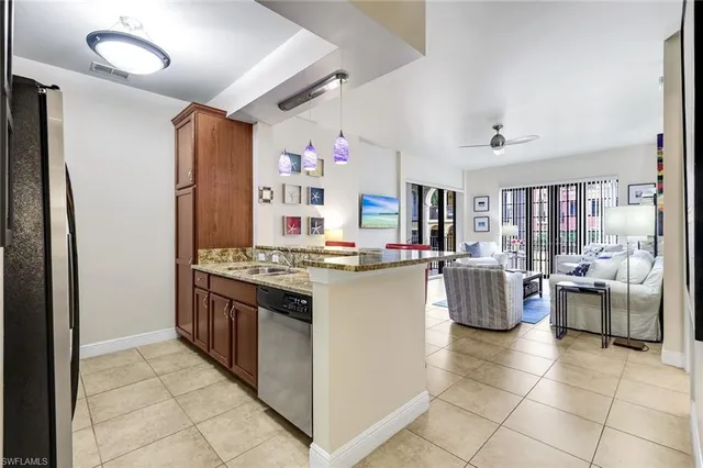 a kitchen with living room and stove top oven