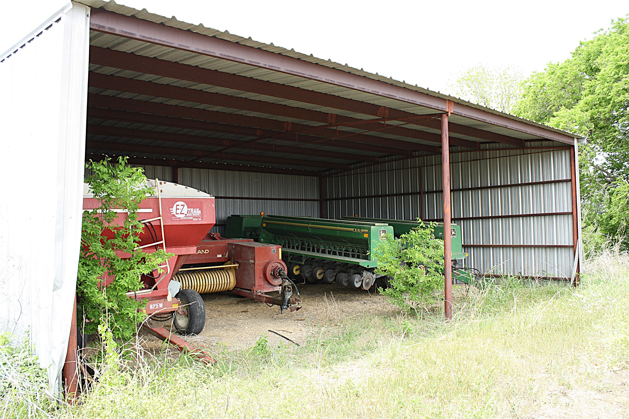 19374 Pennington Branch Road Holland, TX 76534 - Photo 15 of 24 Property includes a metal-framed structure with a corrugated roof and walls, offering covered storage