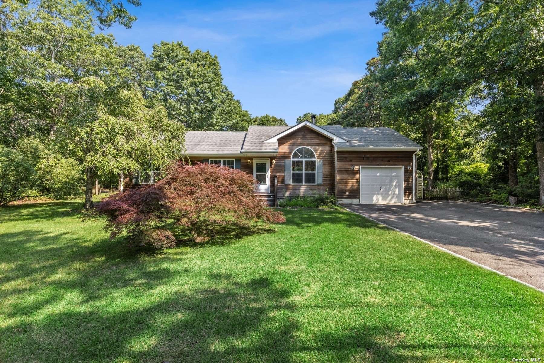 26 Shore Road Hampton Bays, NY 11946 - Photo 1 of 1 a front view of a house with a garden