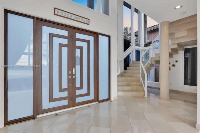 a living room with furniture and a floor to ceiling windows