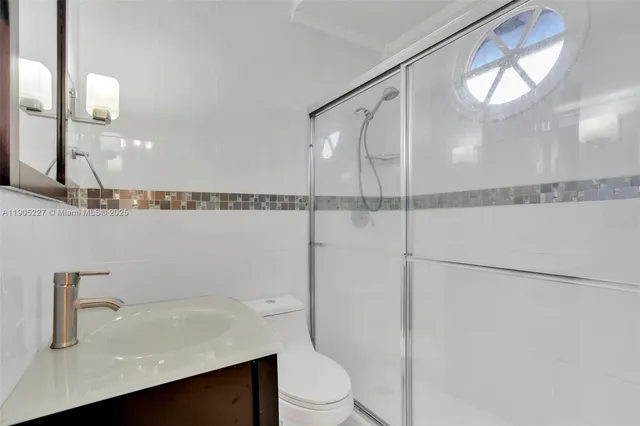 a white toilet sitting next to a shower curtain