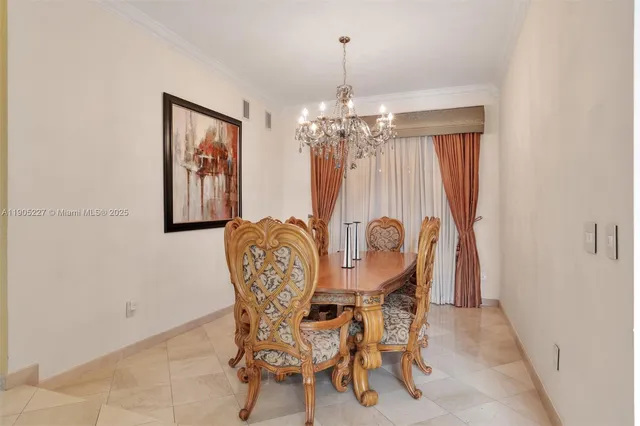 a large white kitchen with a lot of counter space and a sink