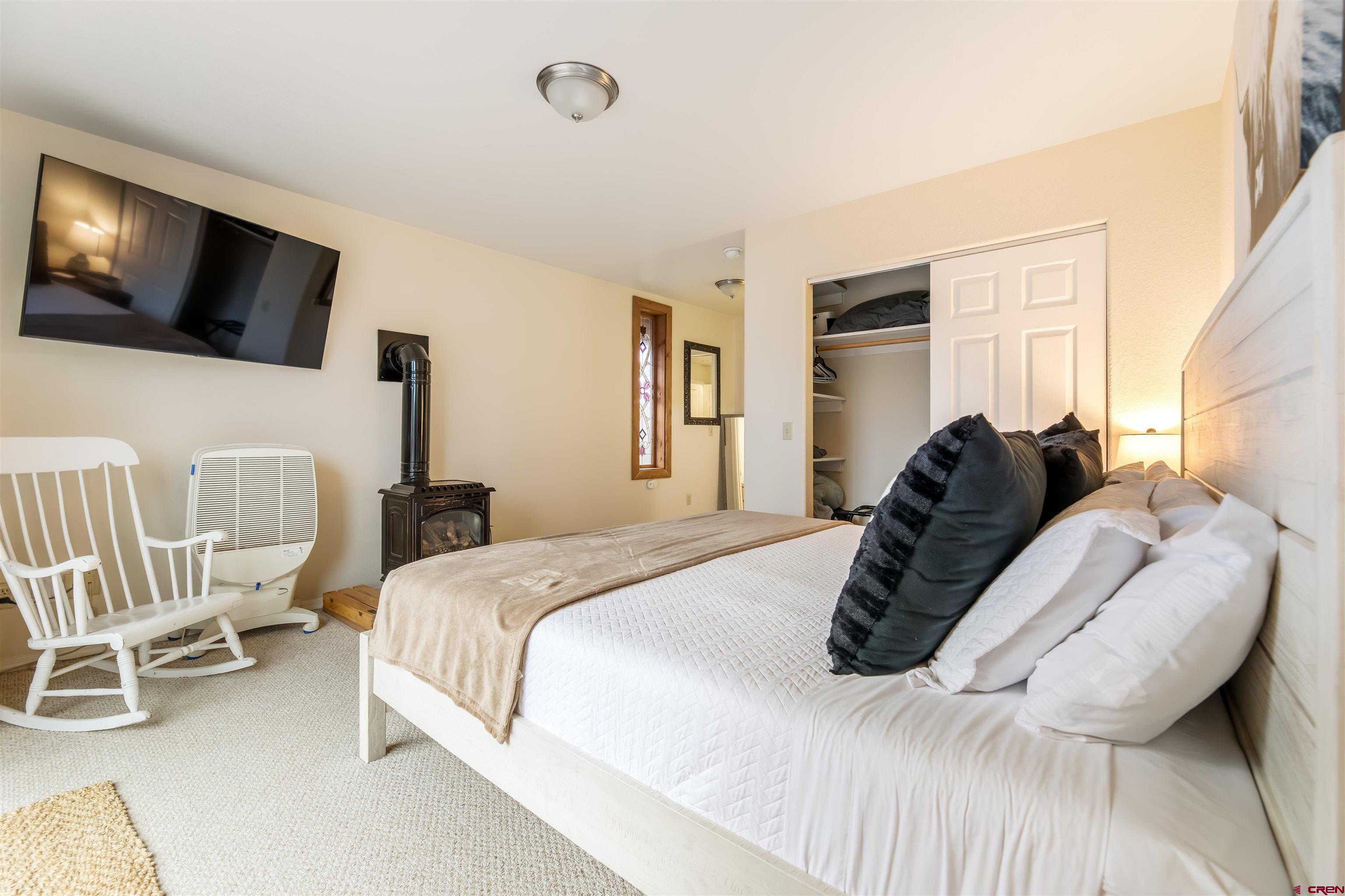 39 Hawk Place Pagosa Springs, CO 81147 - Photo 16 of 37 a bedroom with a bed tv and window