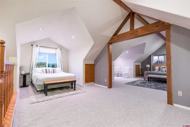 a spacious bedroom with a bed and a window