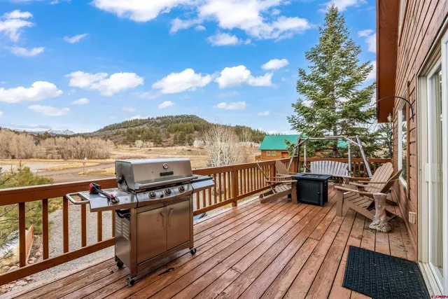 a view of a balcony with wooden floor and outdoor space