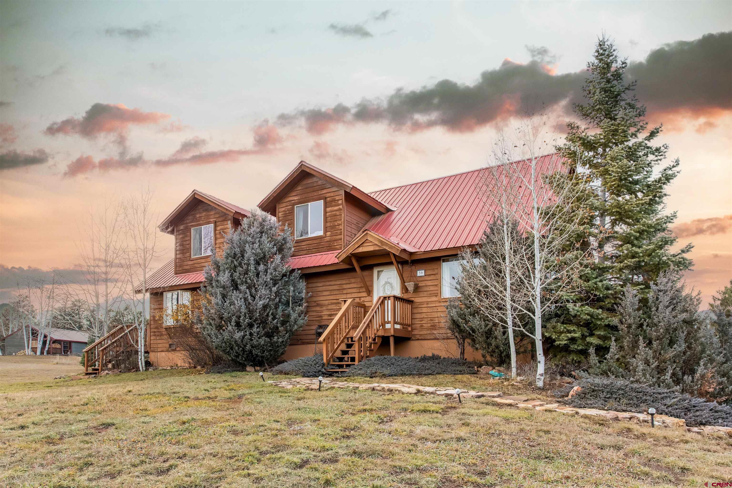 39 Hawk Place Pagosa Springs, CO 81147 - Photo 28 of 37 a view of a house with large trees and a barn