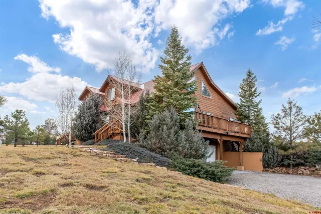a view of a house with a snow in the background