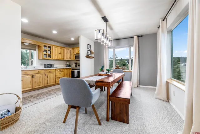 a view of a dining room with furniture window and outside view