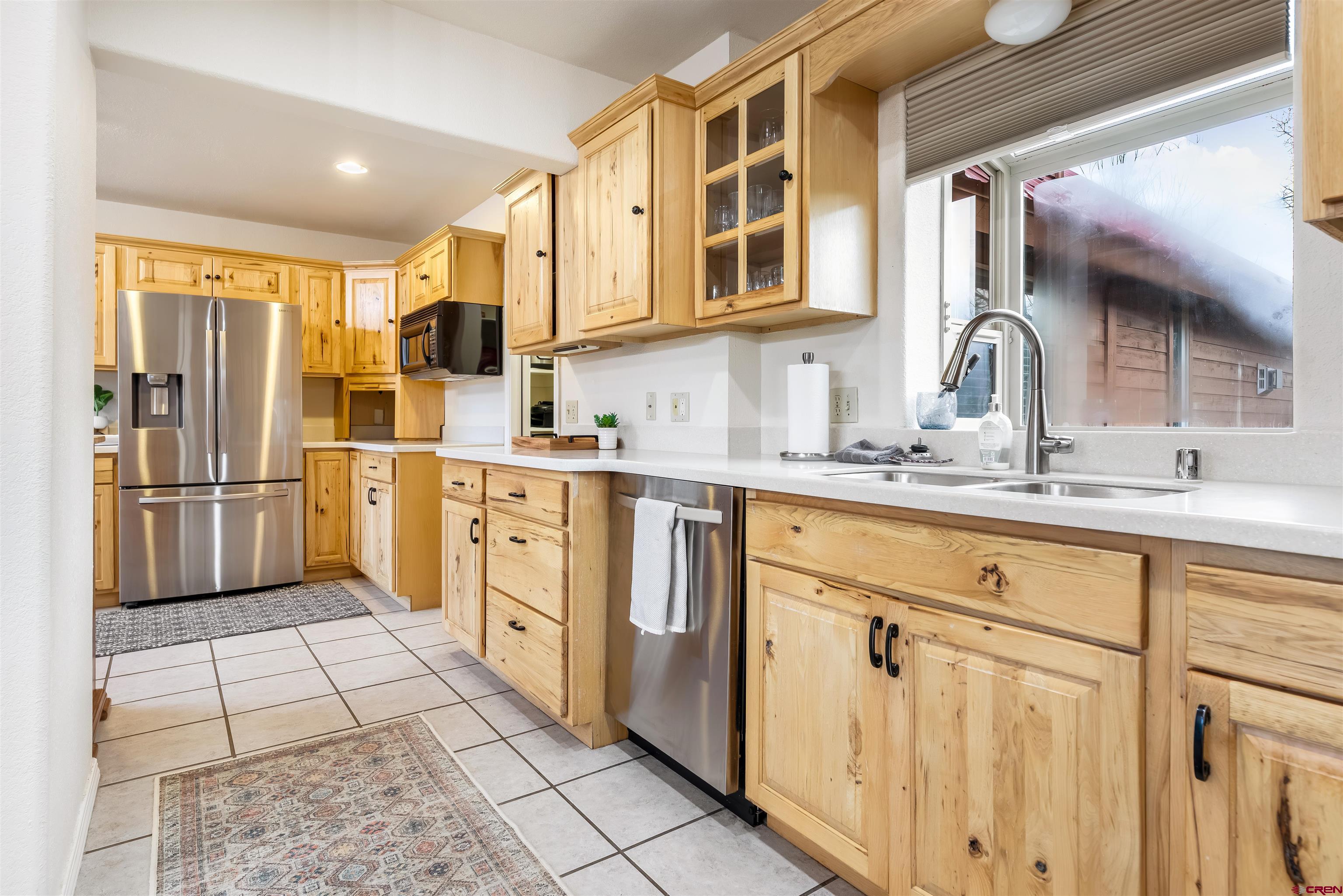 39 Hawk Place Pagosa Springs, CO 81147 - Photo 8 of 37 a kitchen with stainless steel appliances a refrigerator sink and cabinets