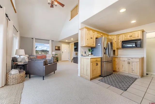 a living room with furniture and kitchen view
