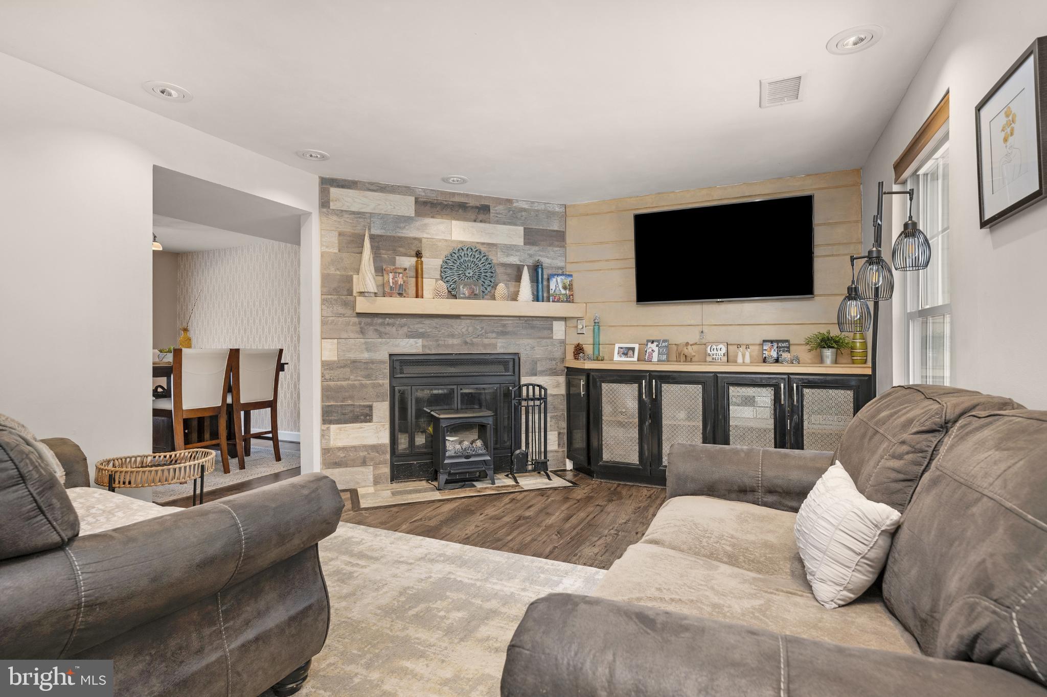 1688 Secretariat Drive Annapolis, MD 21409 - Photo 3 of 20 a living room with furniture a flat screen tv and a fireplace