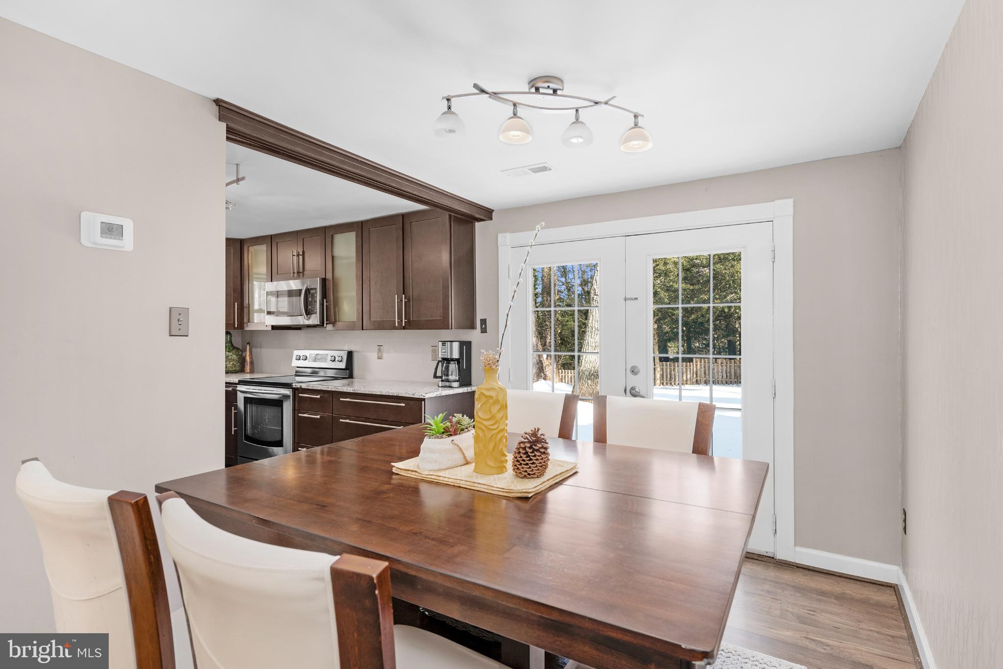 1688 Secretariat Drive Annapolis, MD 21409 - Photo 6 of 20 a view of a dining room with furniture window and wooden floor