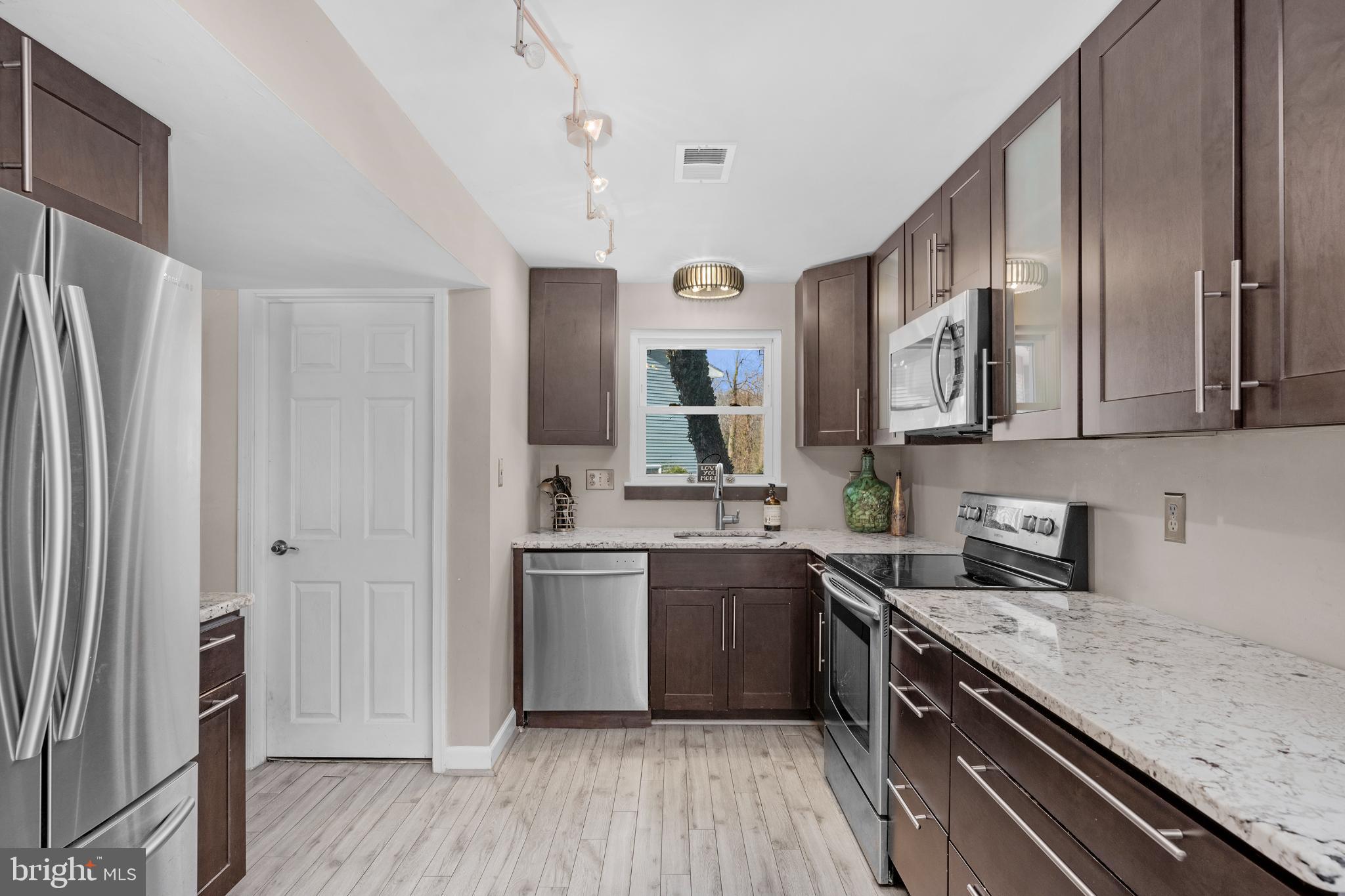 1688 Secretariat Drive Annapolis, MD 21409 - Photo 7 of 20 a kitchen with stainless steel appliances granite countertop a sink stove and refrigerator