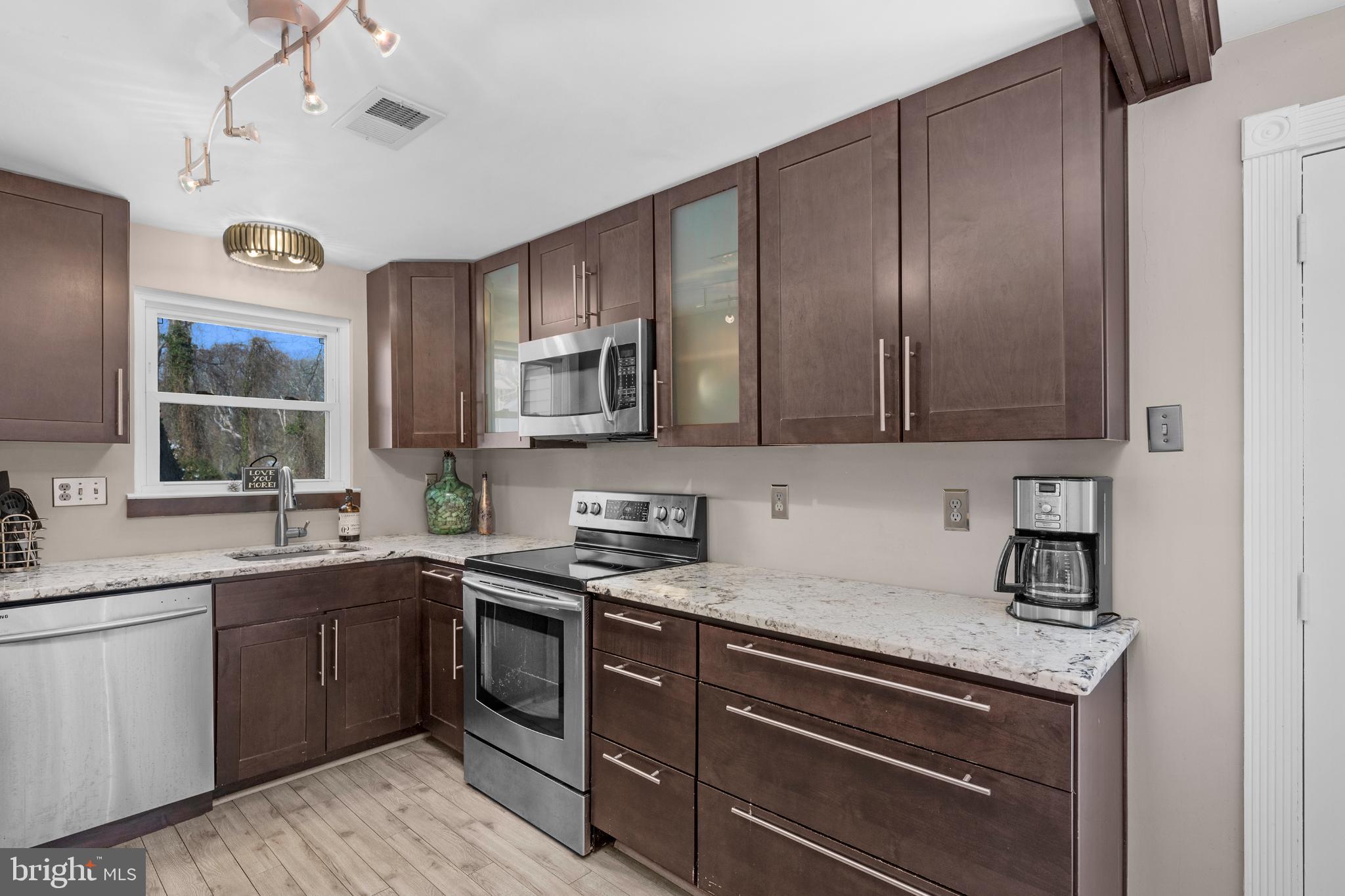 1688 Secretariat Drive Annapolis, MD 21409 - Photo 8 of 20 a kitchen with a sink stove and microwave