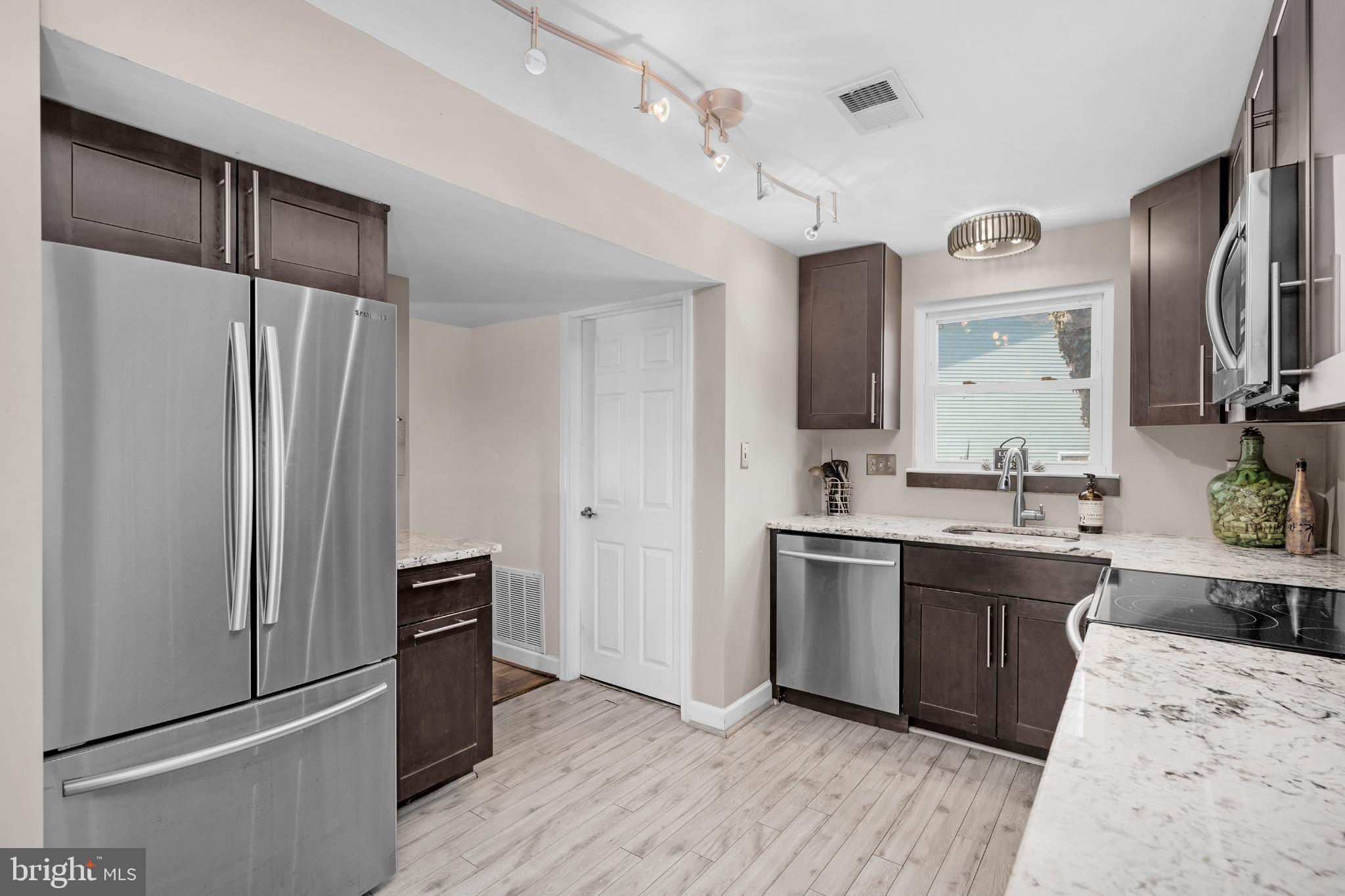 1688 Secretariat Drive Annapolis, MD 21409 - Photo 9 of 20 a kitchen with stainless steel appliances a sink stove and refrigerator