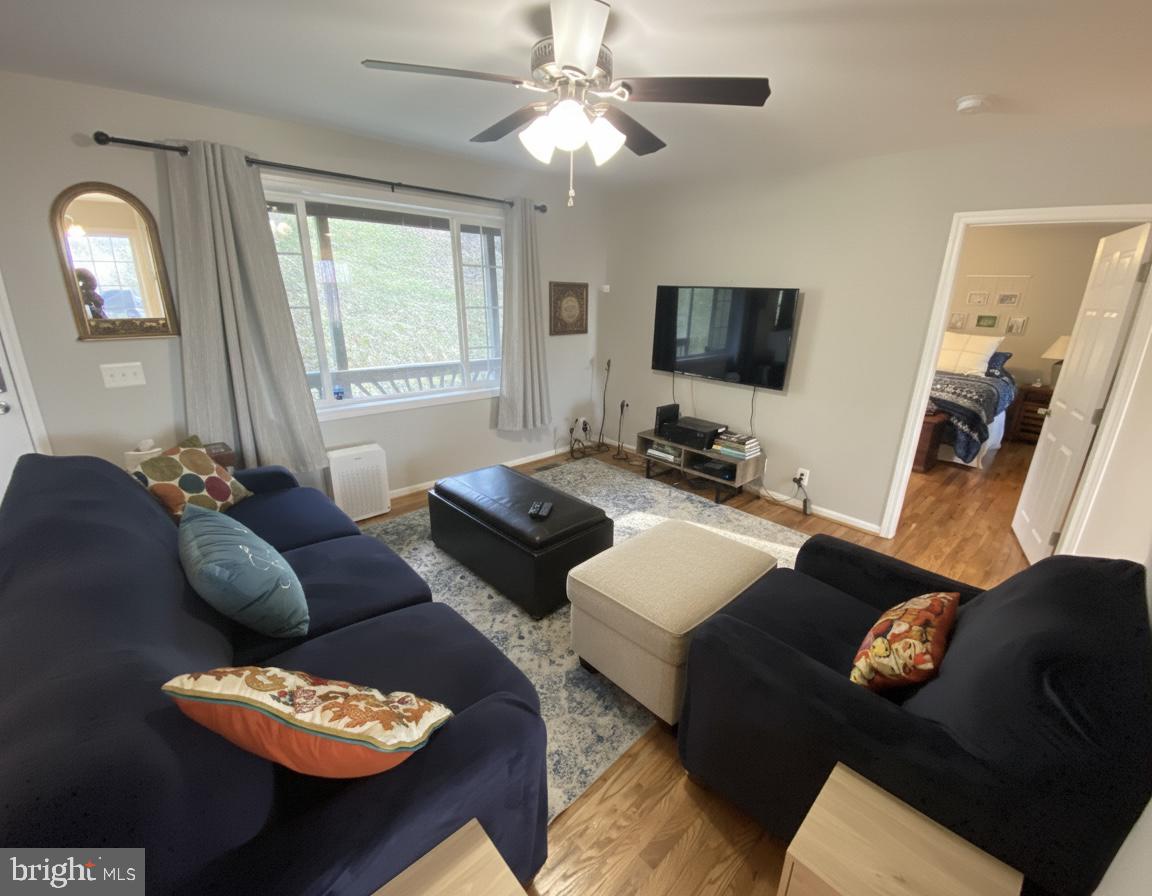 397 Parkside Road Linden, VA 22642 - Photo 15 of 32 a living room with furniture and a flat screen tv