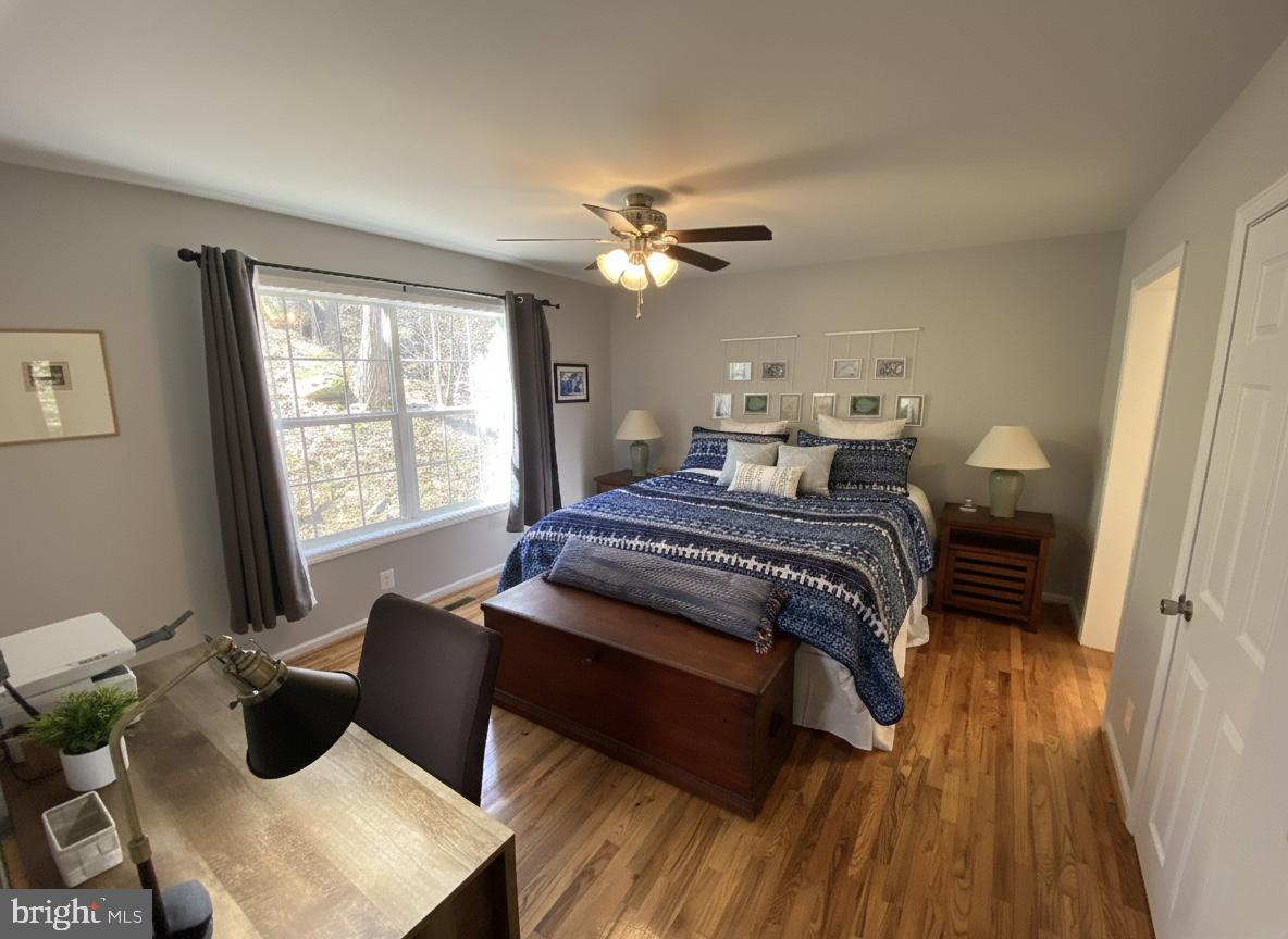397 Parkside Road Linden, VA 22642 - Photo 16 of 32 a bedroom with a bed and wooden floor