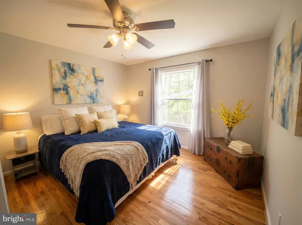 a spacious bedroom with a bed and a window
