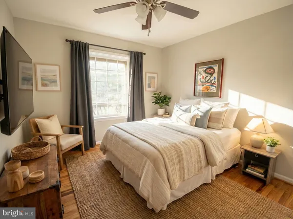 a bedroom with bed and wooden floor