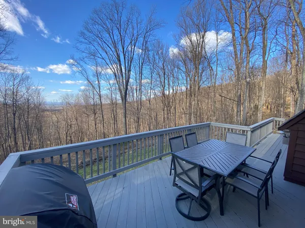 a view of balcony with wooden floor and outdoor seating