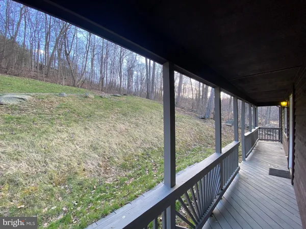 a view of a porch with wooden floor and outdoor space