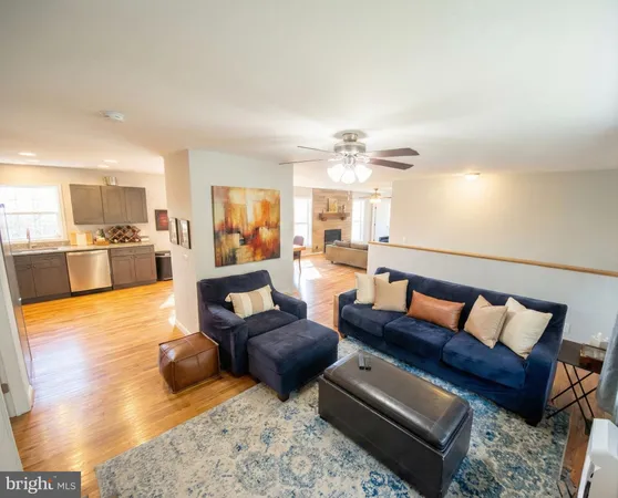 a living room with furniture and a kitchen view