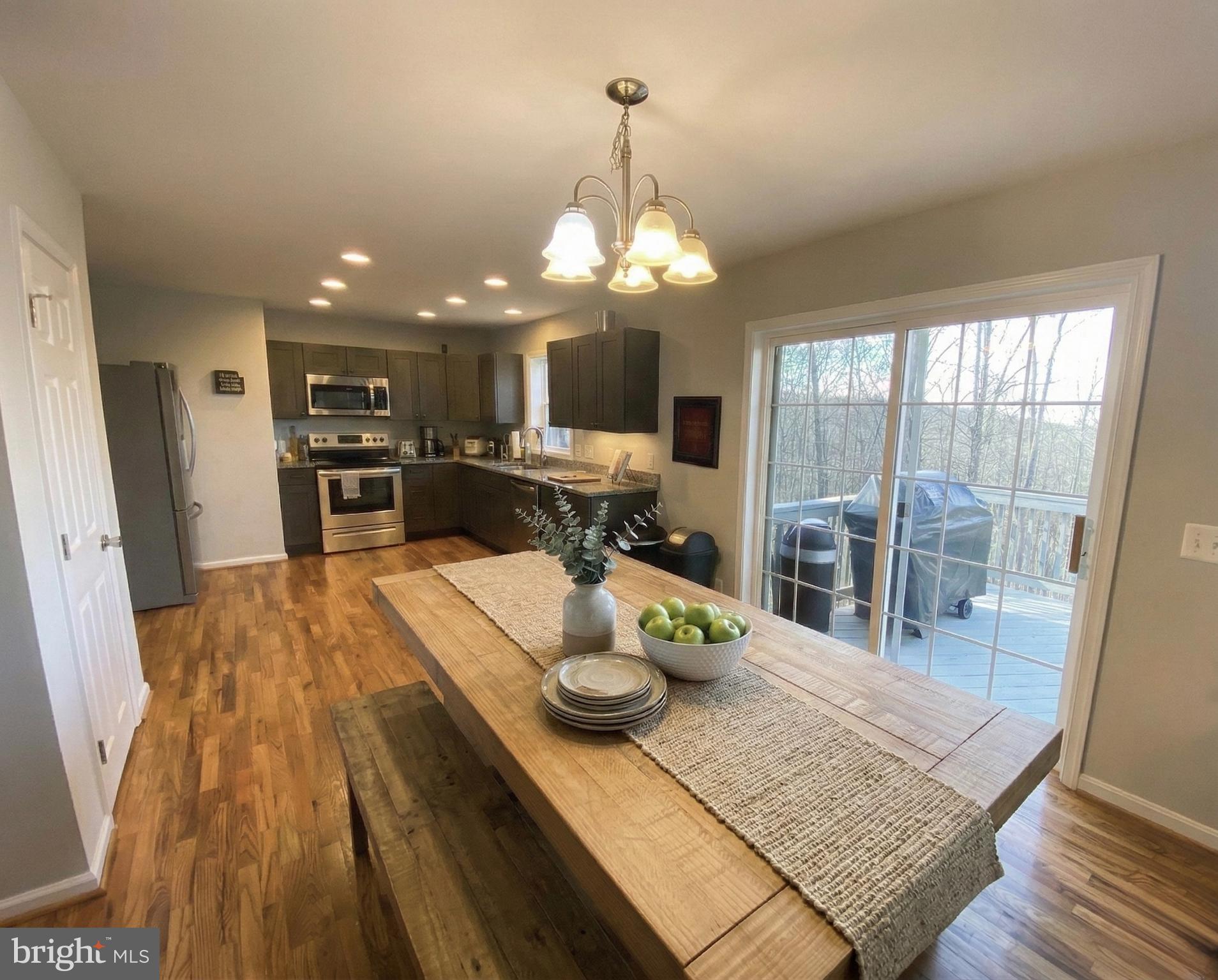 397 Parkside Road Linden, VA 22642 - Photo 6 of 32 a view of a dining room with furniture a chandelier and wooden floor