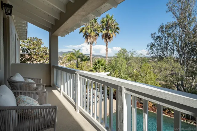 a view of a balcony with furniture