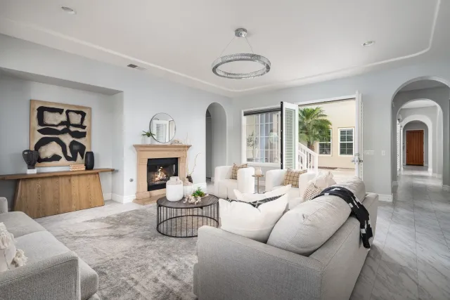 a living room with furniture a fireplace and a large window