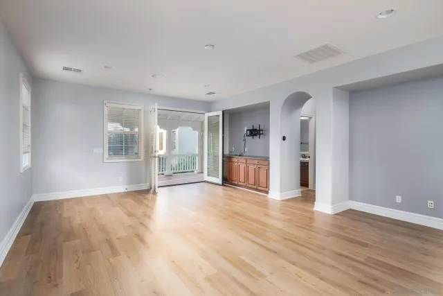 a view of an empty room with wooden floor
