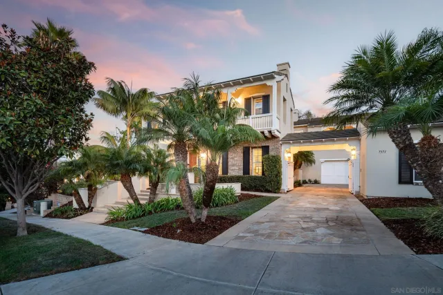 a front view of a house with garden and plants