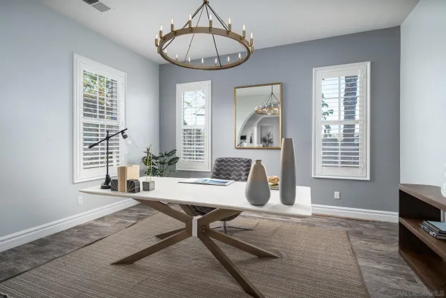 a living room with furniture a flat screen tv and windows
