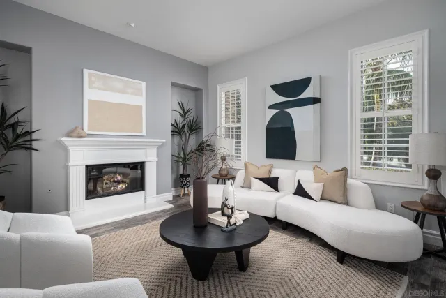 a living room with furniture a fireplace and window