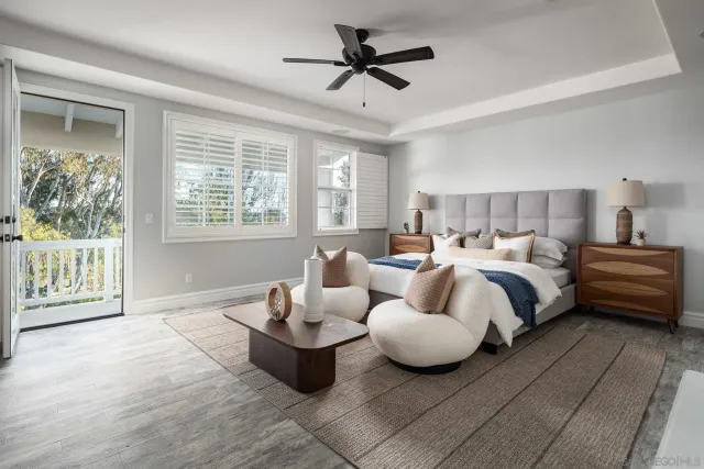 a spacious bedroom with a bed and glass door