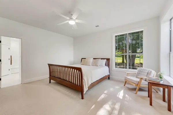 a bed sitting in a bedroom next to a window