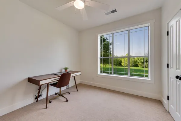 a view of a room with furniture and a window