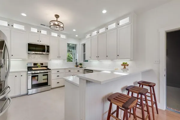 a kitchen with a stove a sink and a refrigerator