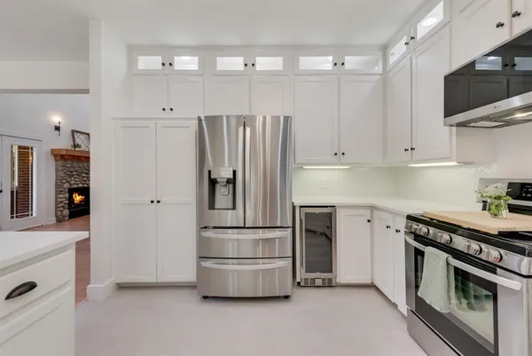 a kitchen with stainless steel appliances a refrigerator stove and microwave