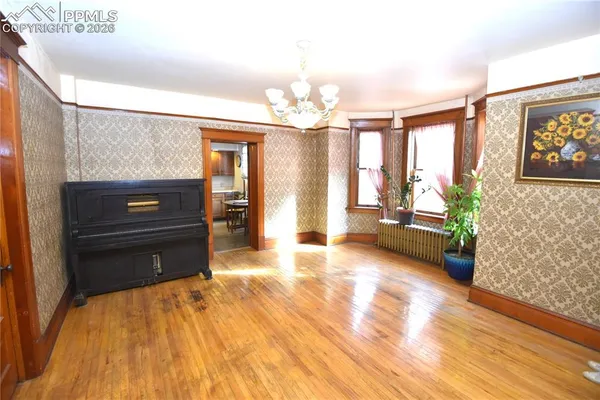 a living room with furniture and a chandelier