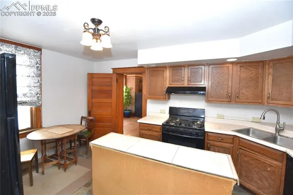 a kitchen with granite countertop a sink stainless steel appliances and cabinets