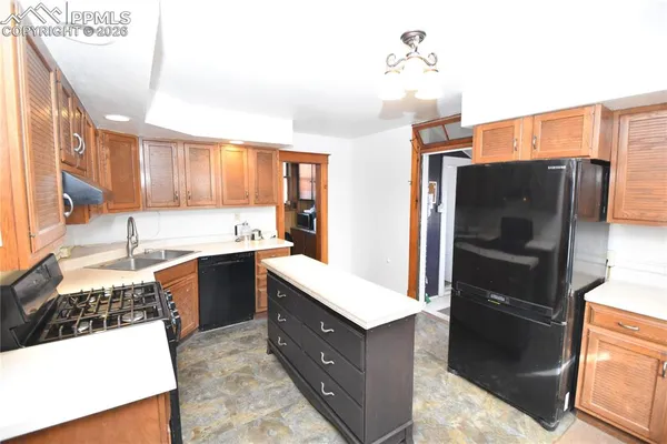 a kitchen with stainless steel appliances a refrigerator sink and stove