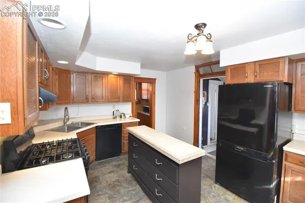 a kitchen with a sink and refrigerator
