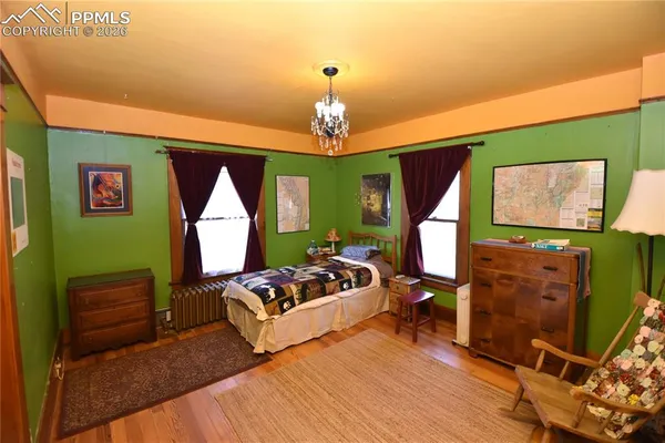 a bedroom with furniture and a flat screen tv