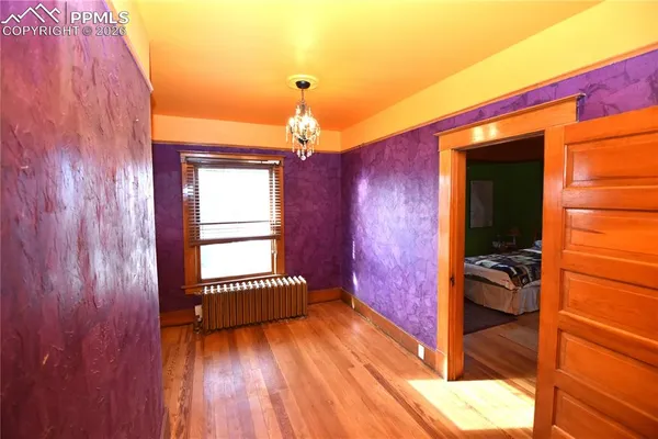 a hallway with a bed and a window
