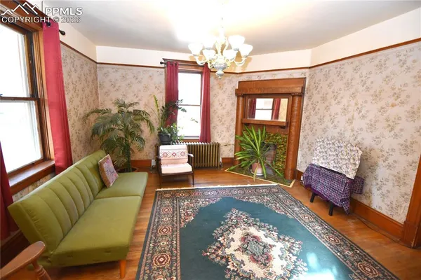 a living room with furniture and a chandelier