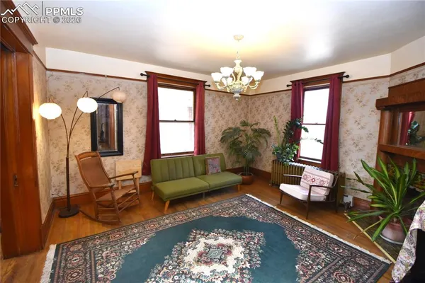 a living room with furniture and a chandelier