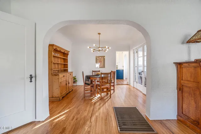 a view of a dining room with furniture wooden floor and chandelier