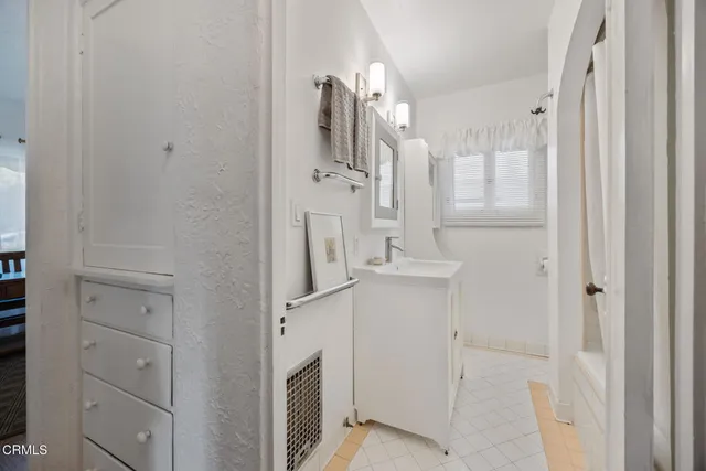 a view of a hallway with wooden floor windows and a livingroom