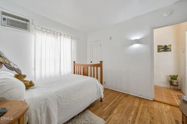 a view of a porch with furniture and wooden floor